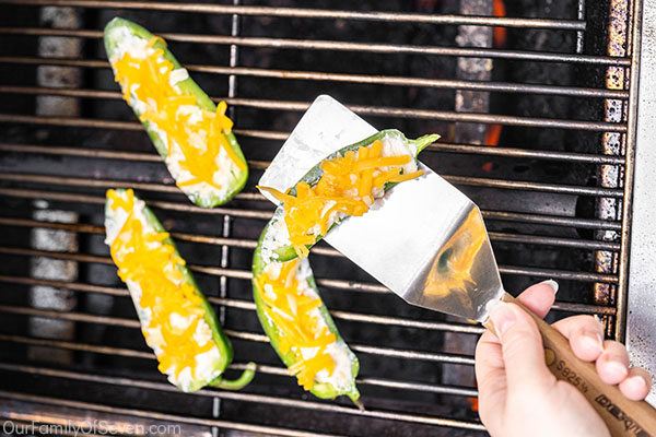 Putting jalapeno pepper on grill